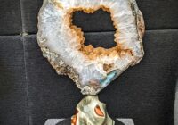 Uruguayan Calcite covered in Druzy geode slice mounted on Polychrome Jasper sculpture created by Leo Atkinson of Stone Art Studios