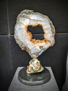 Uruguayan Calcite covered in Druzy geode slice mounted on Polychrome Jasper sculpture created by Leo Atkinson of Stone Art Studios