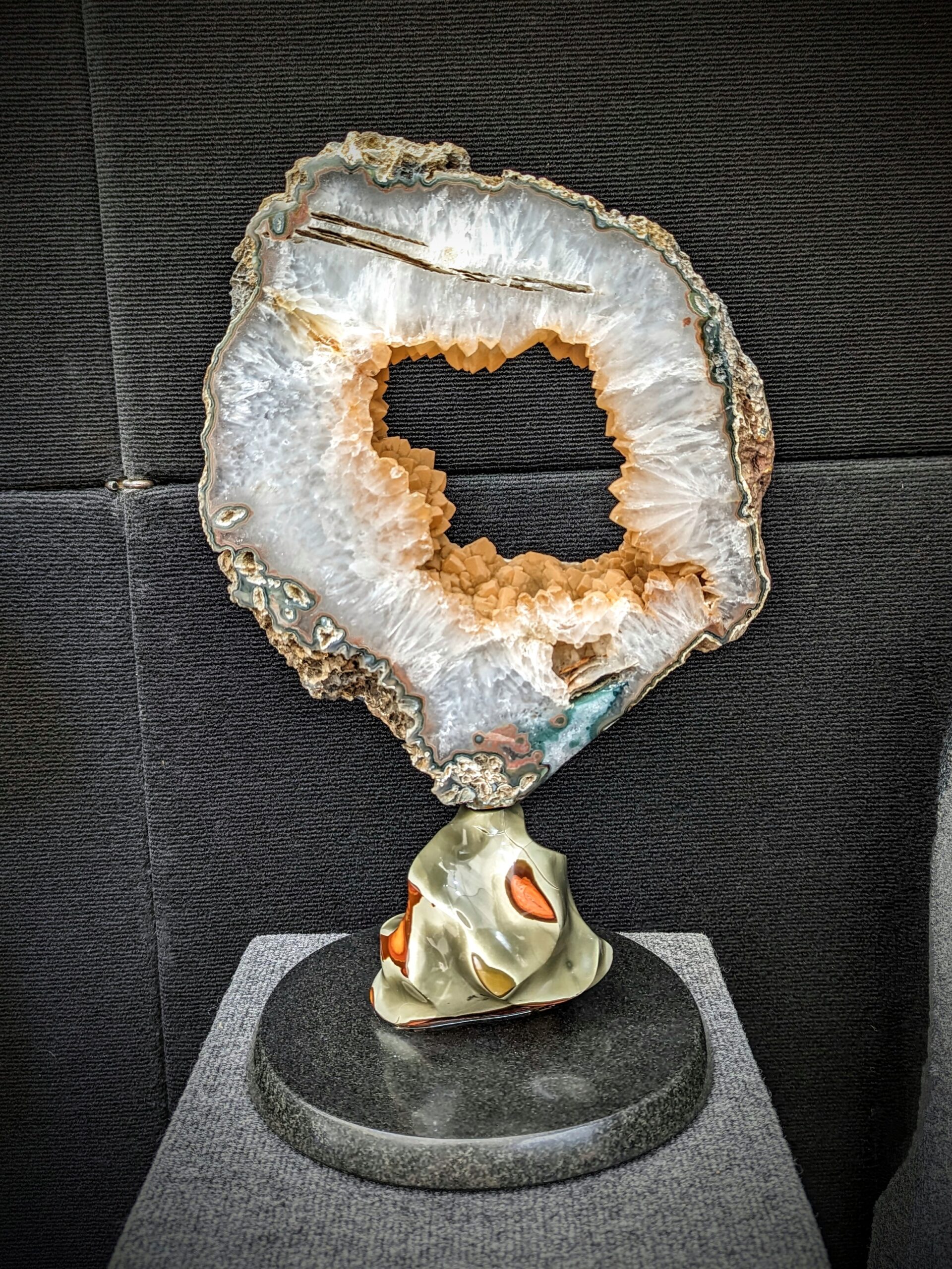 Uruguayan Calcite covered in Druzy geode slice mounted on Polychrome Jasper sculpture created by Leo Atkinson of Stone Art Studios